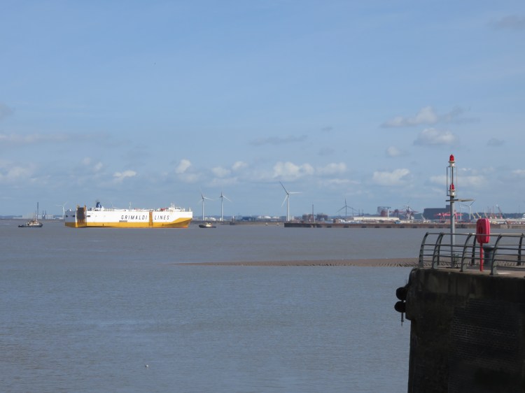 A car carrier being guided into Bristol Port
